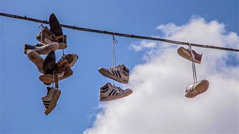 shoes hanging on power lines meaning.